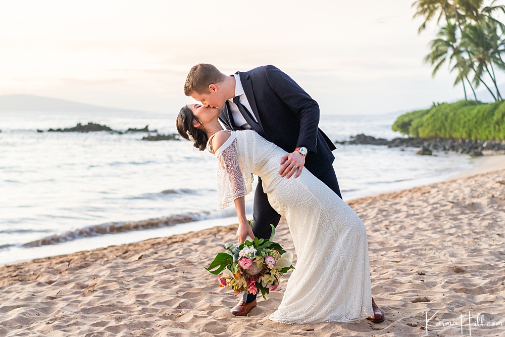 Bride and groom kissing on the beach 