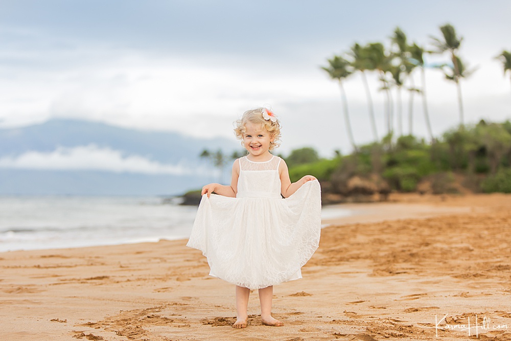 best Maui family photographer - cute little girl on the beach - girl in white dress