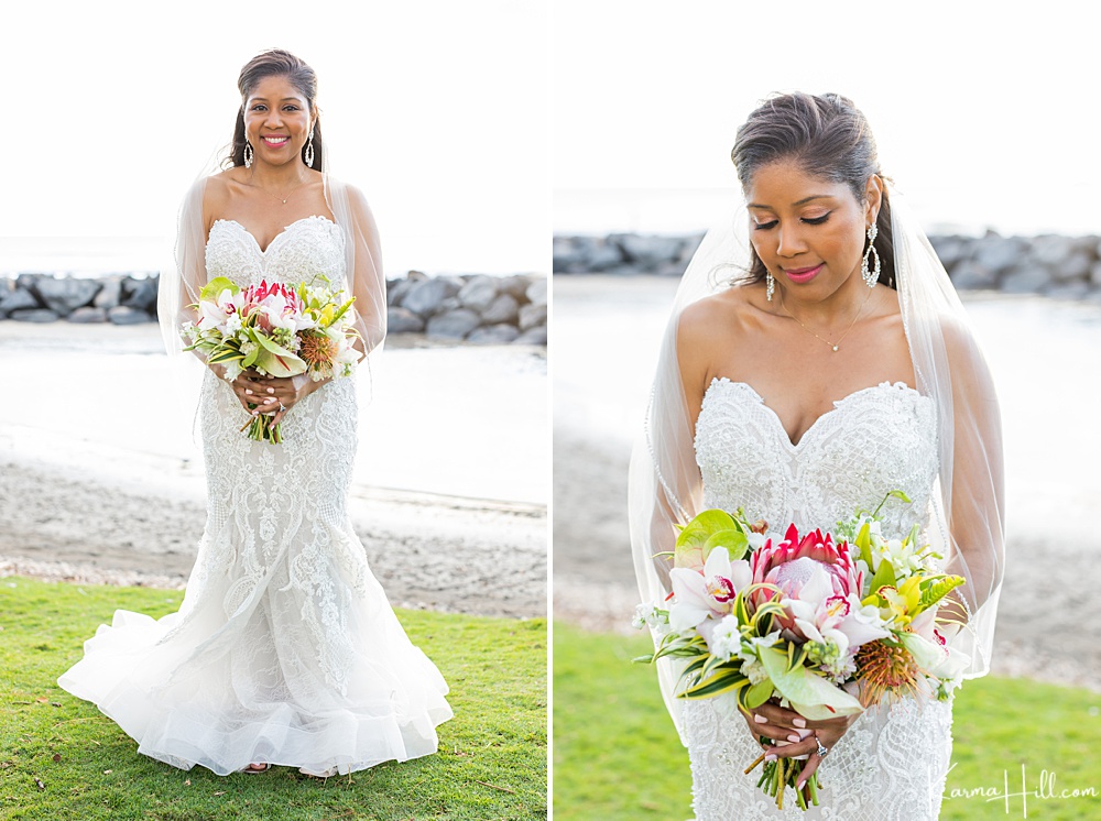 beautiful bride with bouquet standing near the ocean 