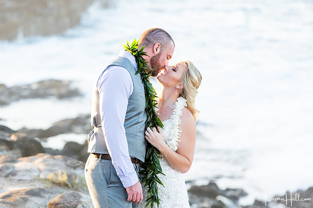 bride and groom kissing on beach 
