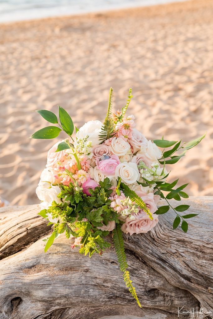 rose wedding bouquet on beach driftwood