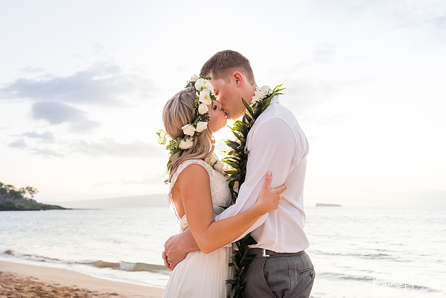 young couple kissing during wedding in hawaii 