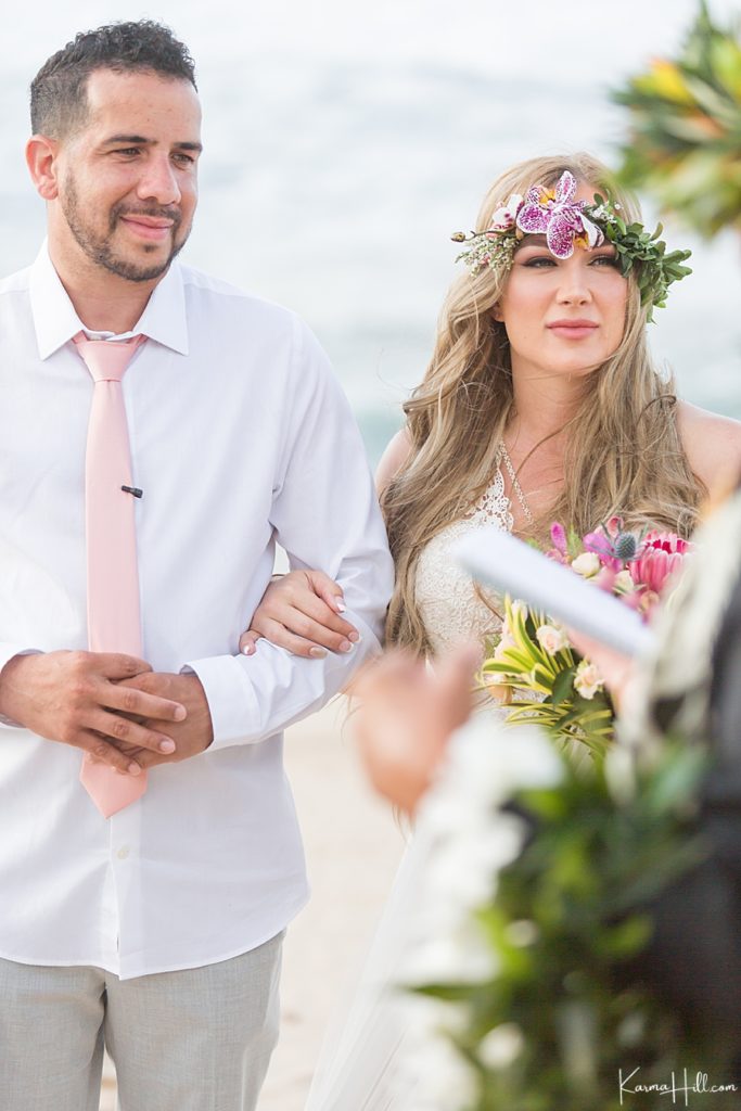 bride and groom with flower crown and pink accents 