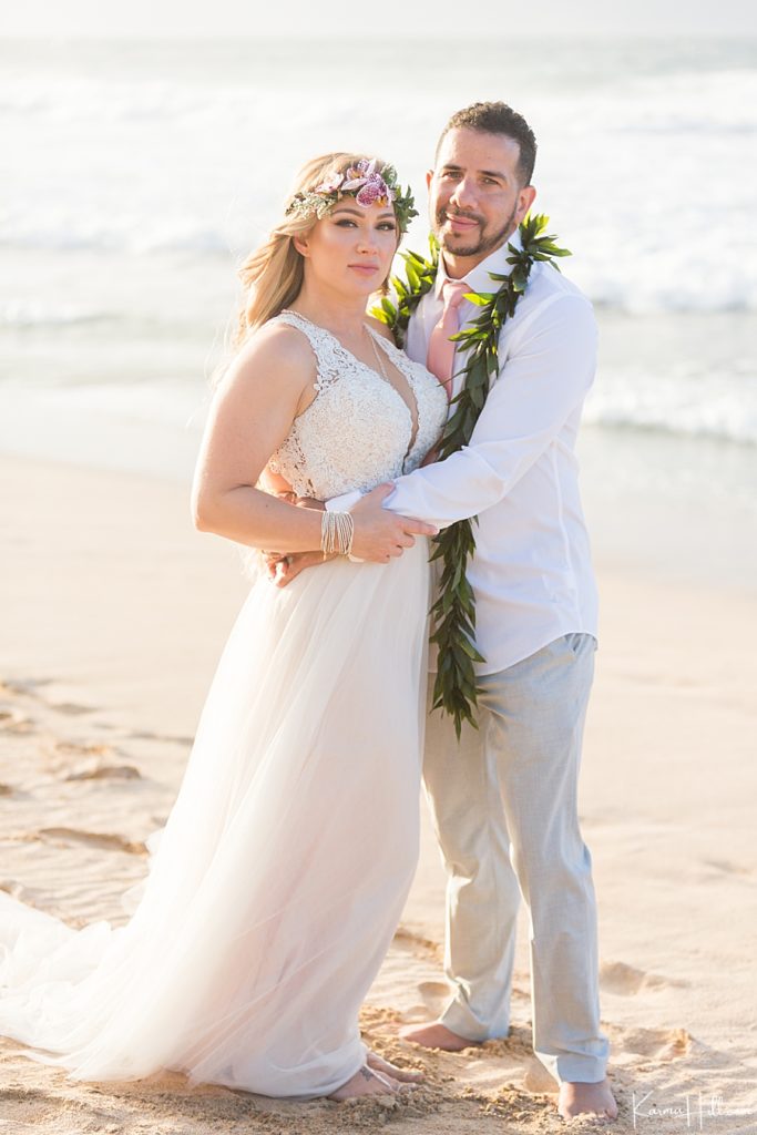 bride and groom embrace on maui beach 