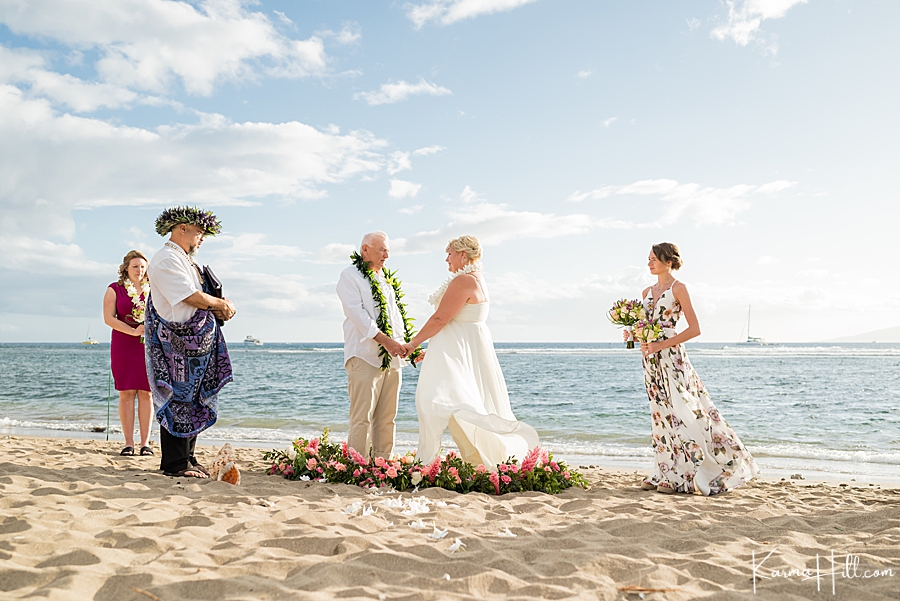 older couple standing in a flower circle during their maui wedding 