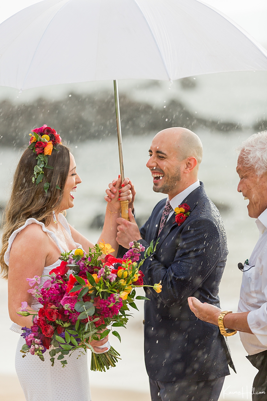 couple laughing in the rain during their hawaii wedding 