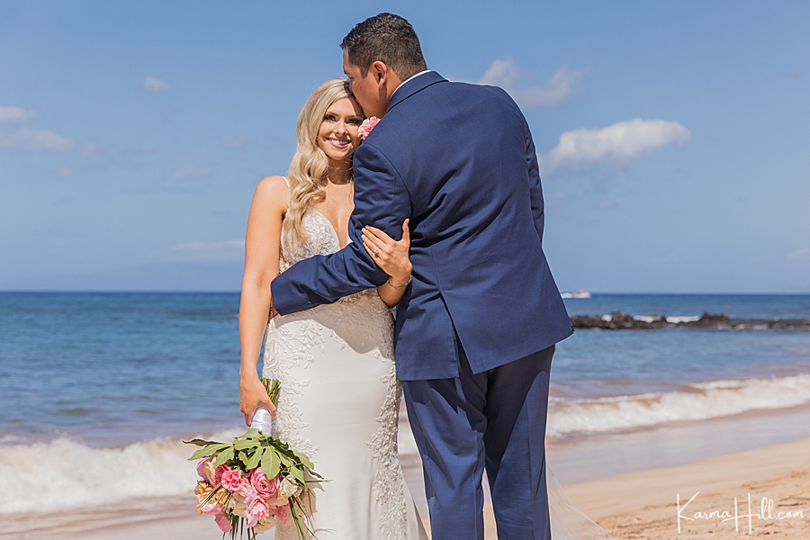 bride and groom pose for couple photography on maui beach 