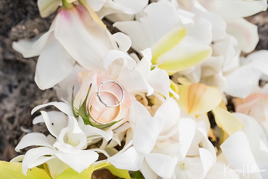 rose gold and silver rings on a lei on a maui beach 