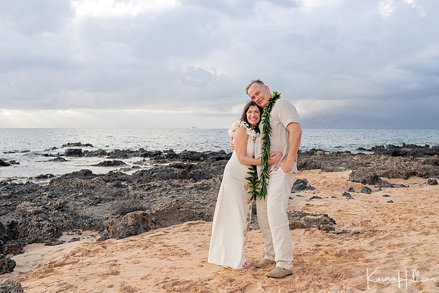 older bride and groom pose on maui beach after their hawaii wedding 