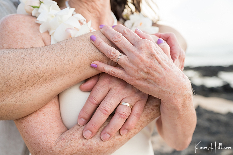 close up of older bride and groom's hands with rings 