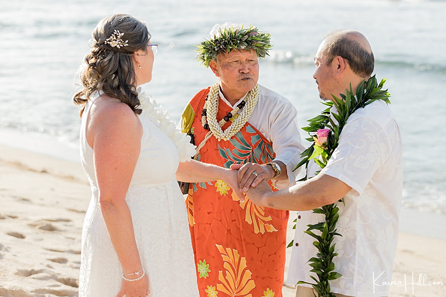 hawaiian reverend blesses a couple during their wedding in hawaii 