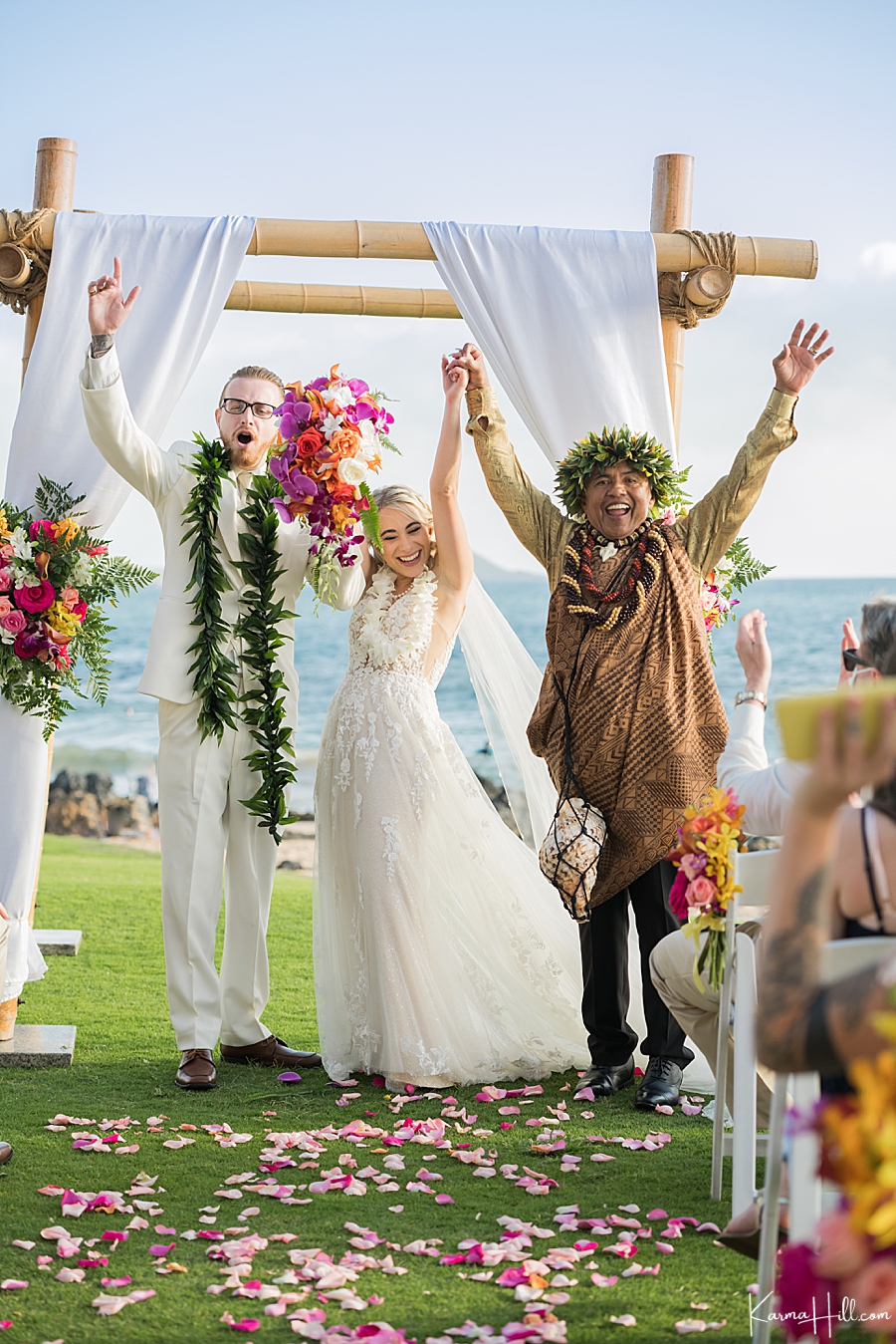 bride and groom celebrate being just married with hawaiian reverend 