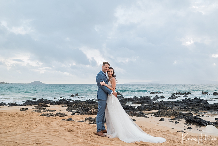 overcast sky with bride and groom on hawaii beach 
