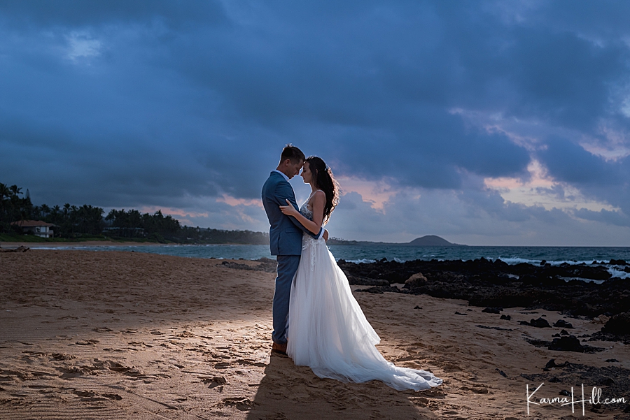 bride and groom with back lighting after sunset on maui beach 