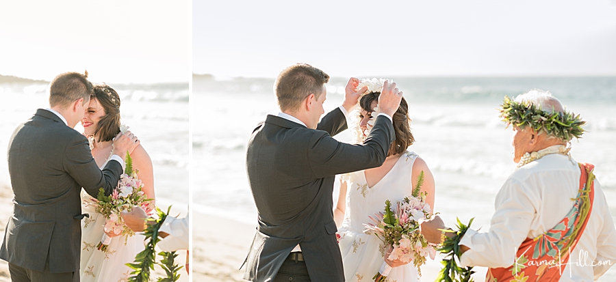 couple exchanging leis during their maui wedding on a beach 