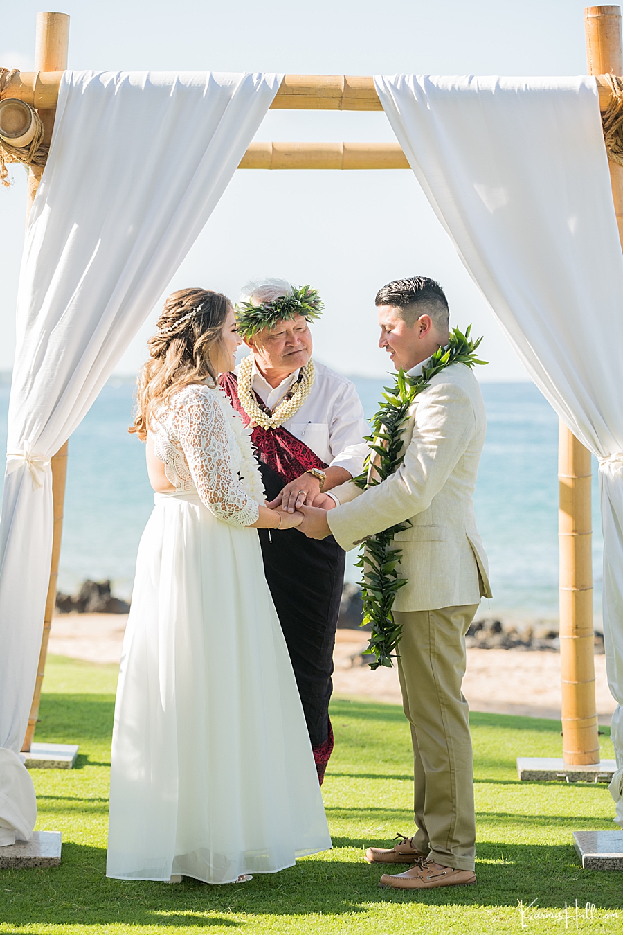 bride and groom pray with hawaiian minister during venue wedding in hawaii 