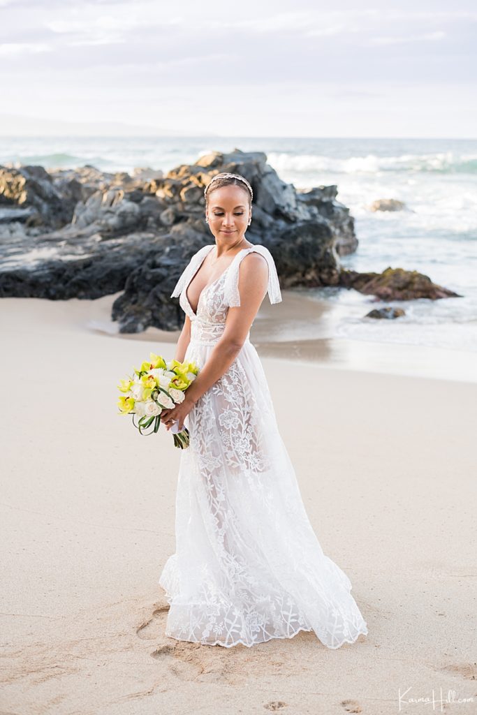 beautiful bride in low-cut gown with floral embroidery by Bronx and Bronco on a beach in hawaii 