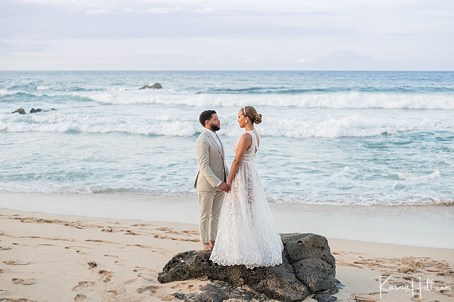 bride and groom look into each other's eyes in front of maui ocean 