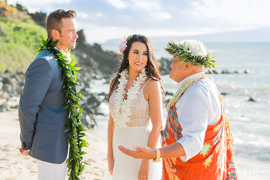 vow renewal photos during ceremony on beach 