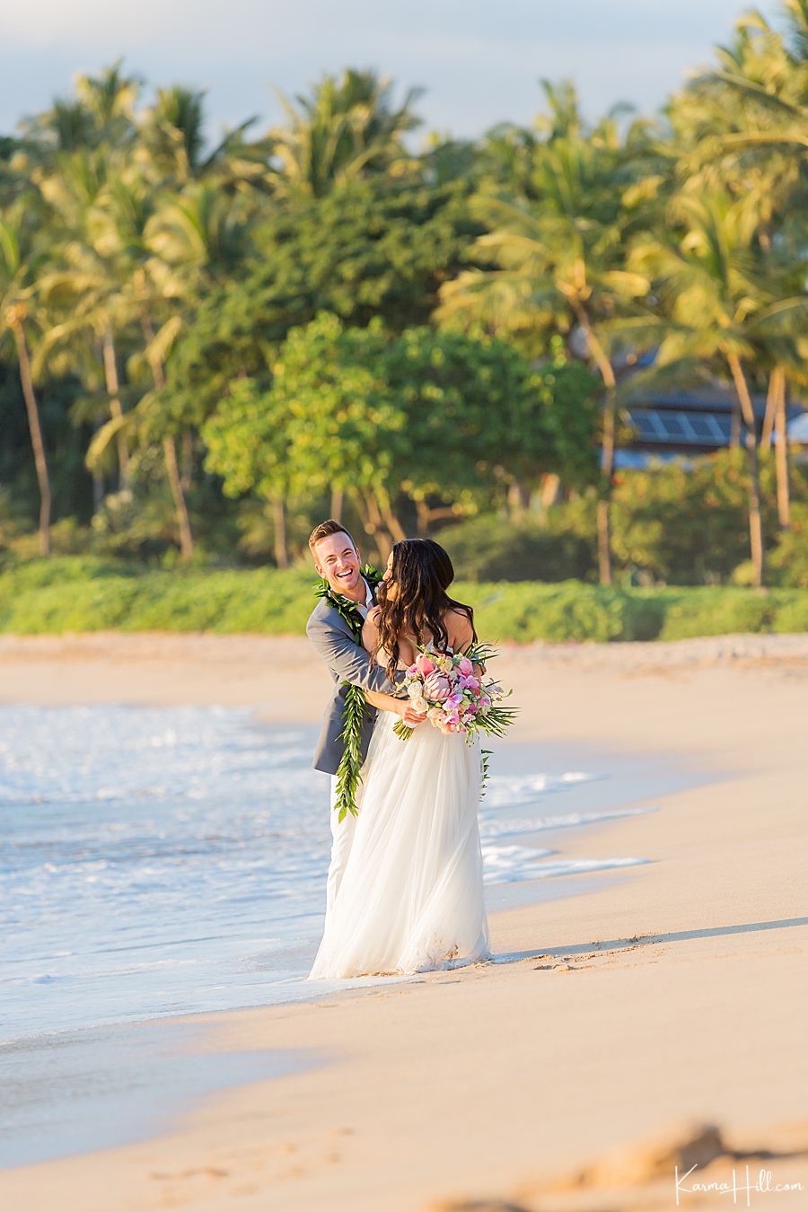 husband and wife embrace on maui beach 