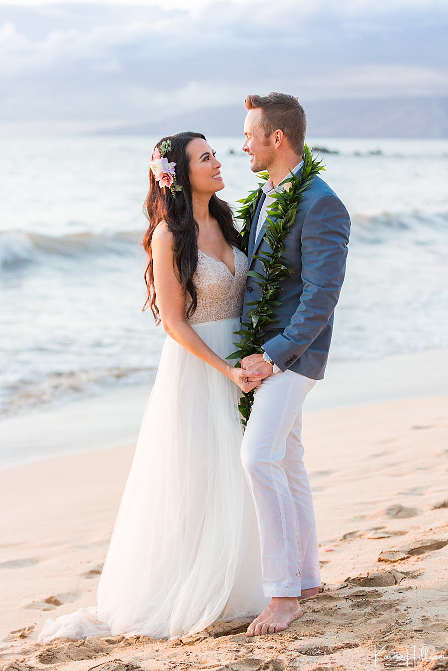 just married couple pose on maui beach 