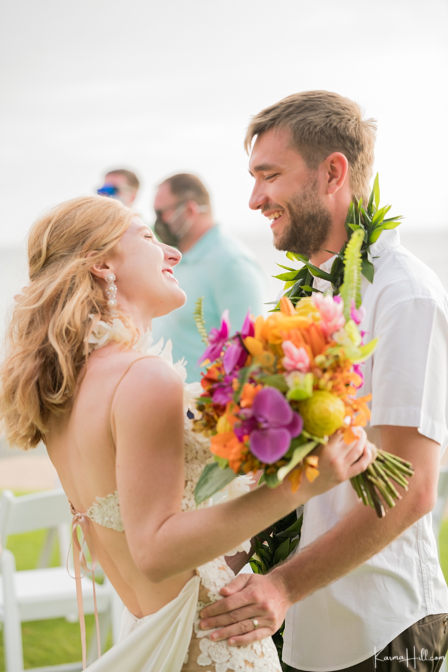 newly weds laugh together after their wedding in hawaii 