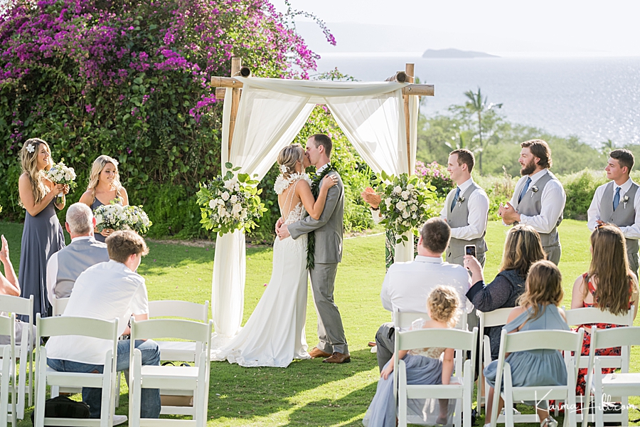 bride and groom share their first kiss in hawaii 