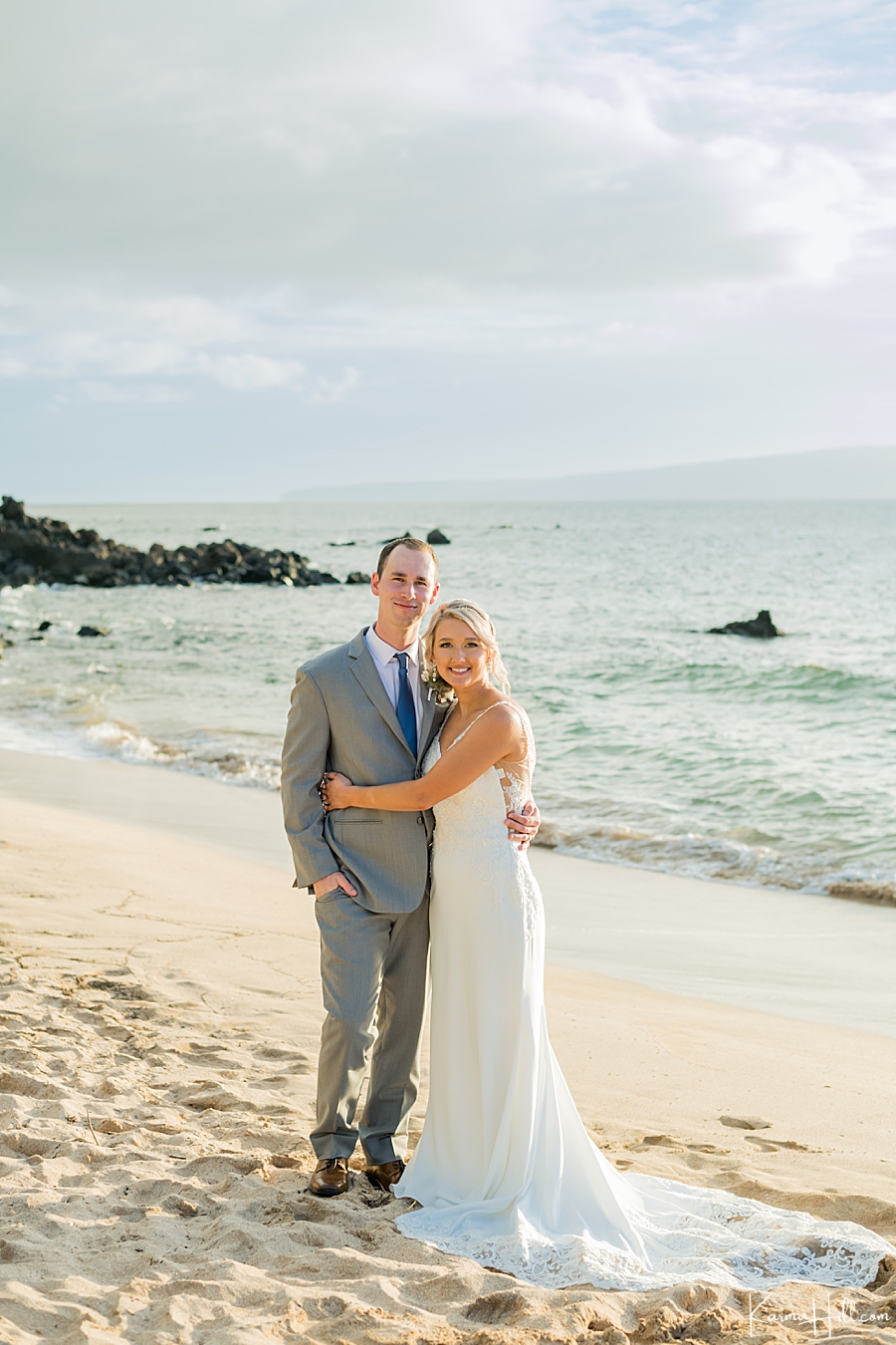 bride and groom embrace on Maui beach 