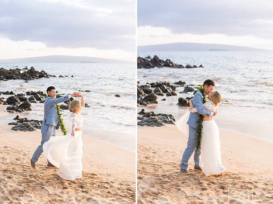 newlywed husband and wife dance and kiss on the beach in hawaii 