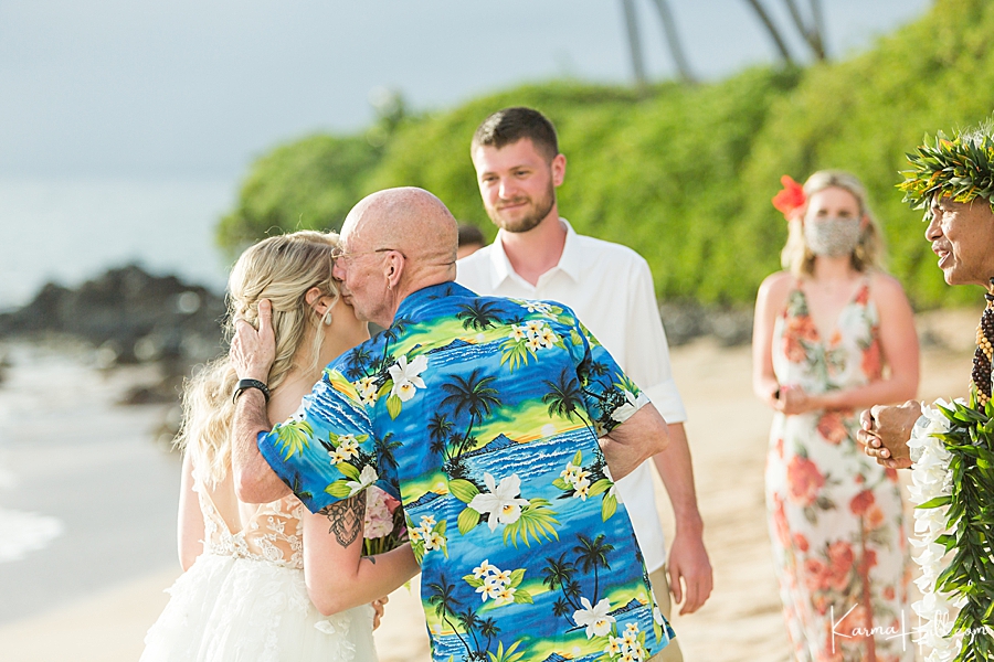 father gives away the bride at a beach wedding in maui 