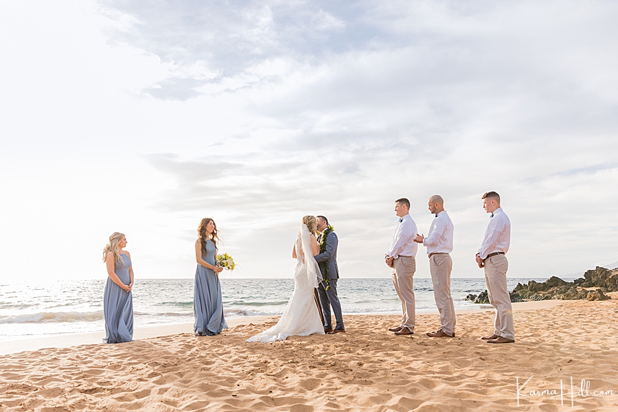 husband and wife kiss during wedding on maui beach 