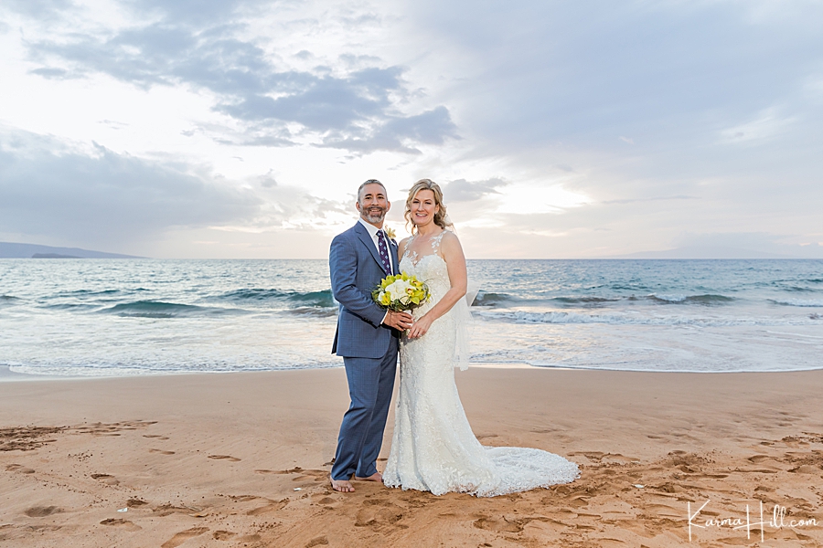 happy bride and groom in front of a hawaii sunset 