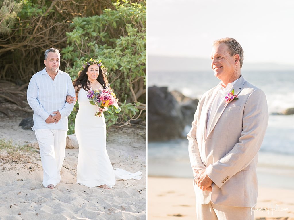 groom's first look as his bride walks onto the shore of ironwoods beach for their hawaii wedding 
