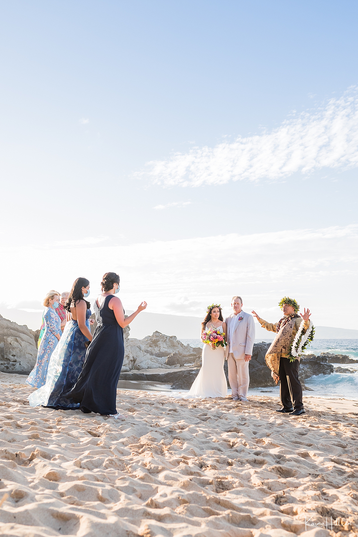 covid beach wedding in hawaii with guests wearing masks and a hawaiian reverend 