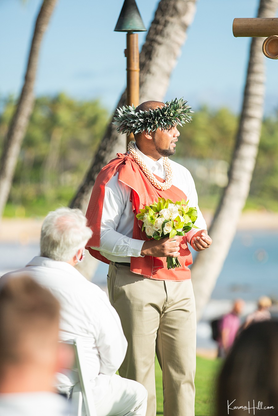 hawaiian minister with haku lei holding bouquet 