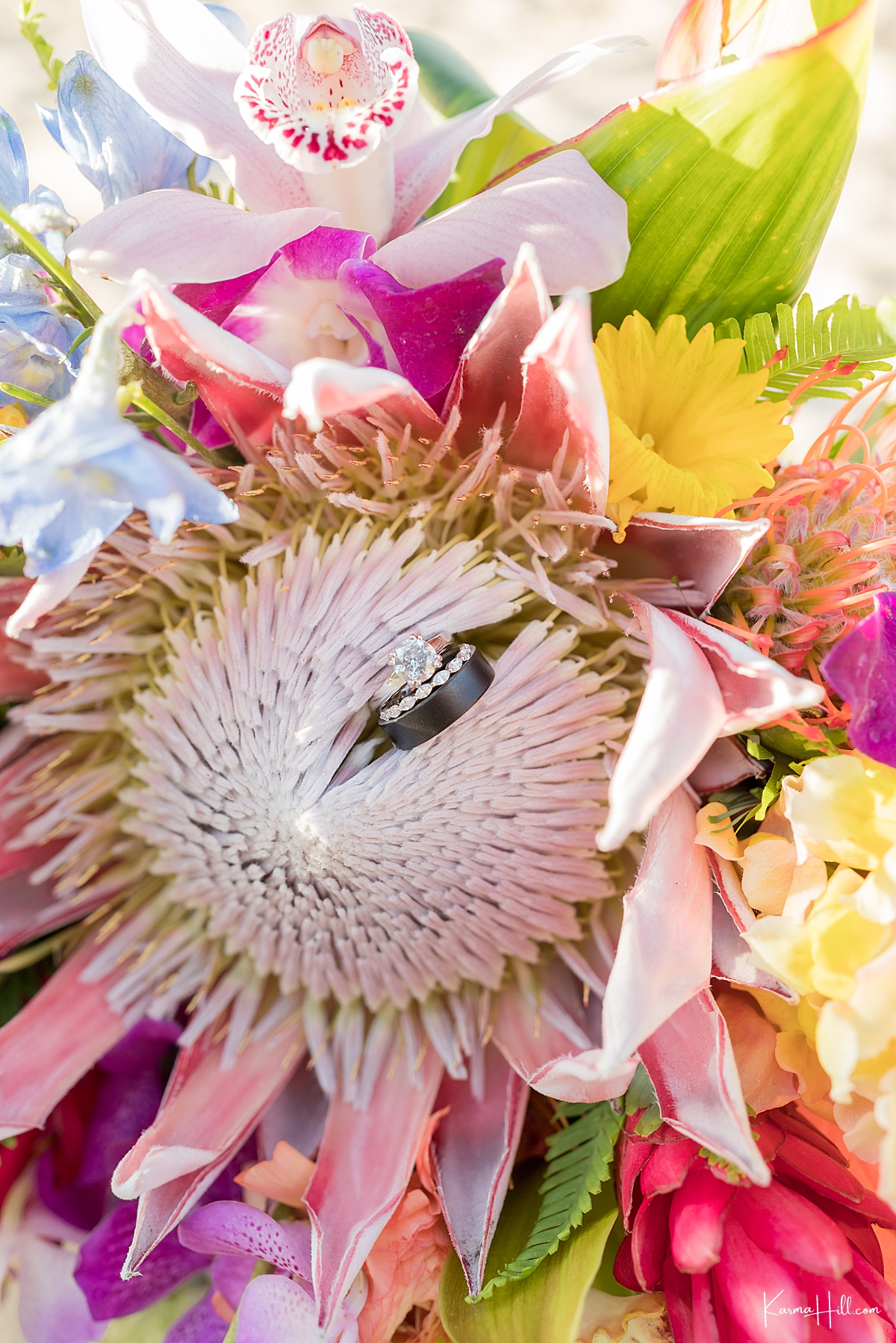 close up of rings in a hawaii beach wedding bouquet 