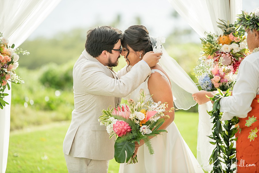 sweet photo of a groom giving bride a white flower lei in hawaii 