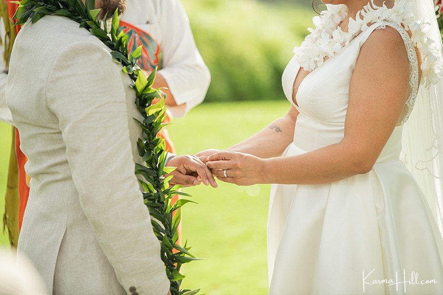 bride and groom exchange rings at gannon's restaurant in maui 
