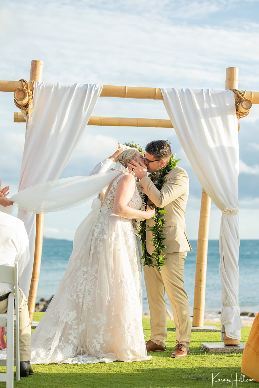 couple kiss during their wedding at the 5 palms in maui 