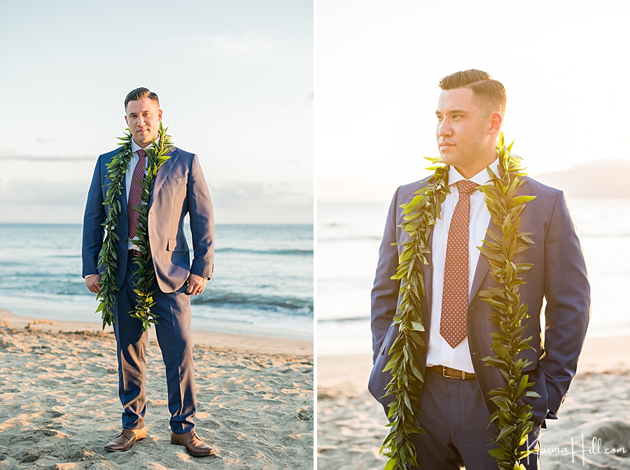 groom in a navy suit with a red polka dot tie and maile lei 