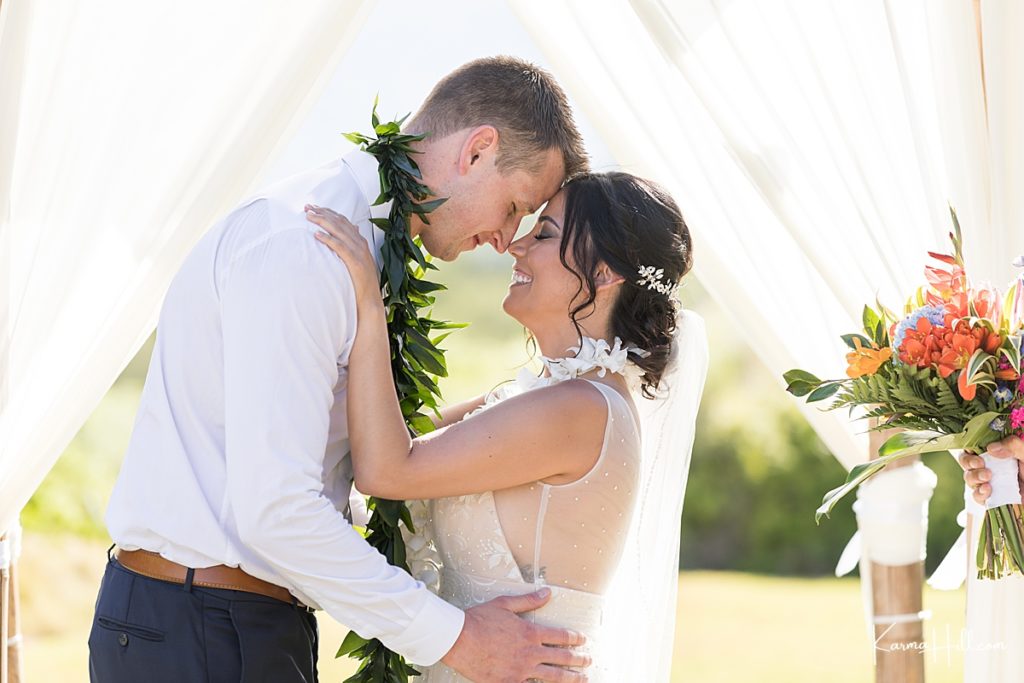 couple touch foreheads during their hawaii venue wedding 