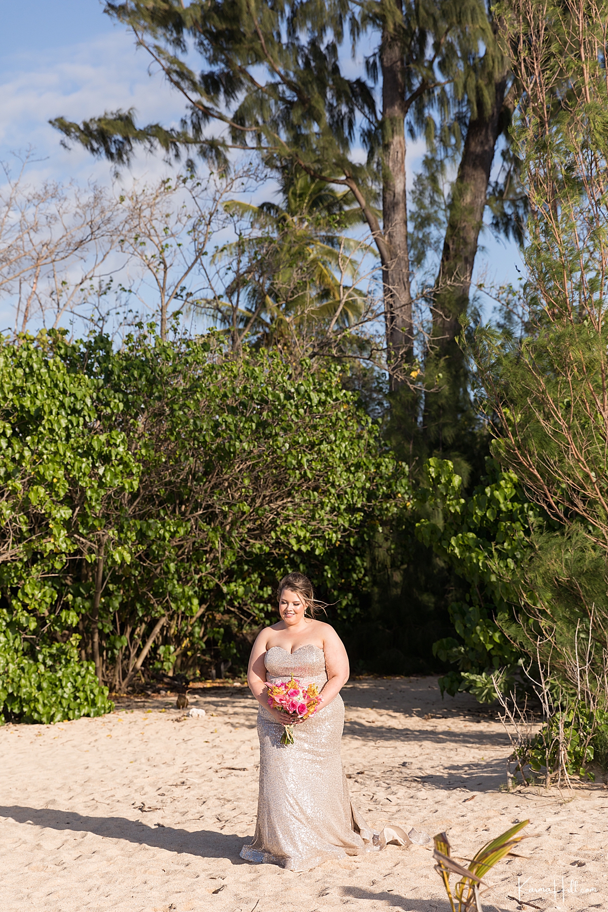 bride in a golden sequence dress enters for her beach wedding in maui 