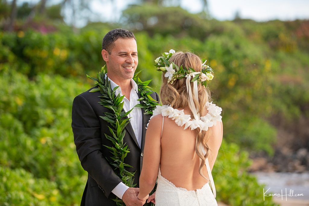groom smiles into his bride's eyes as they elope in hawaii 