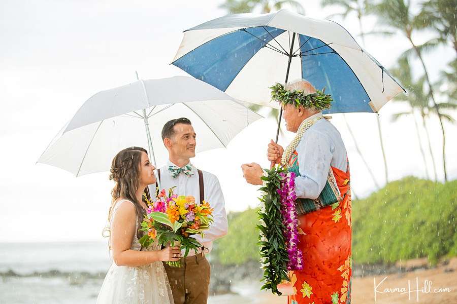 sweet beach wedding with rain and umbrellas