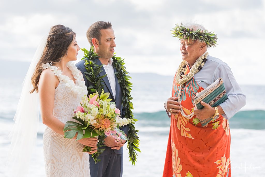 couple get married on maui beach with a hawaiian minister and leis