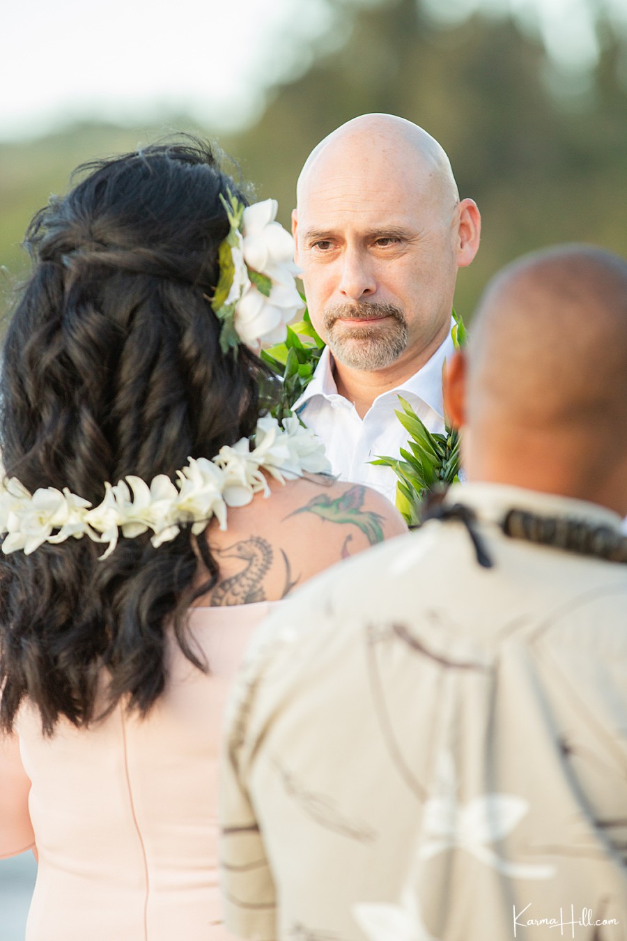 middle aged groom stares lovingly at his bride 