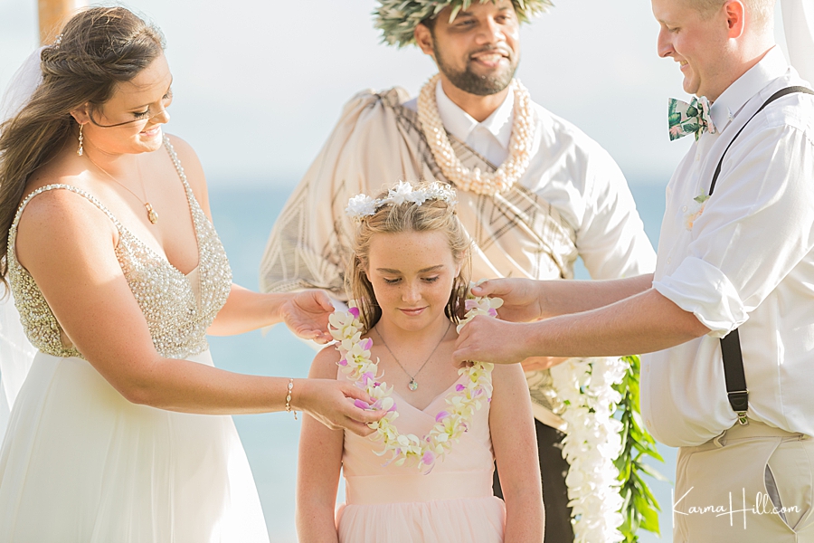 bride and groom give children lei