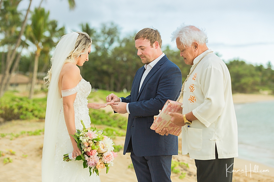 groom exchanging ring with bride