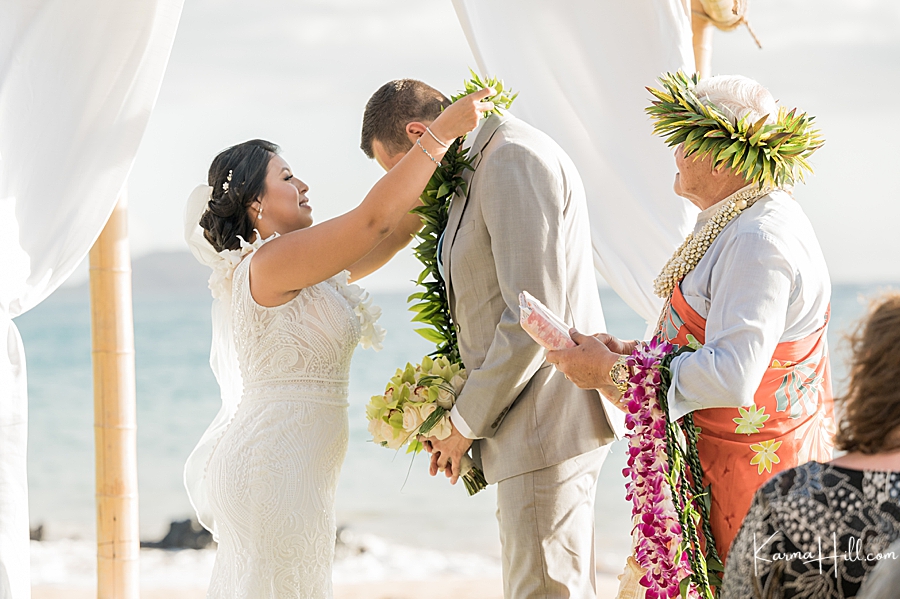 groom exchanging lei with groom