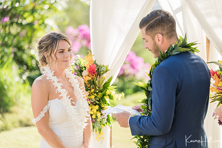 groom exchanging vows with bride at hawaii wedding